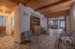 Discover the charm of this inviting property, featuring a warm wooden ceiling and a cozy living area.