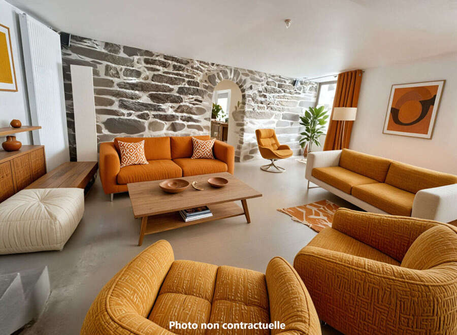 Experience unique living in this stunning living room, featuring a striking stone accent wall and vibrant orange sofas.