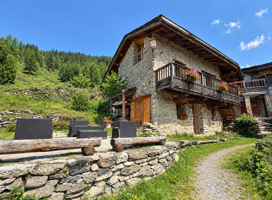 Experience rustic charm in this stone mountain home, nestled amidst lush greenery and offering breathtaking views.