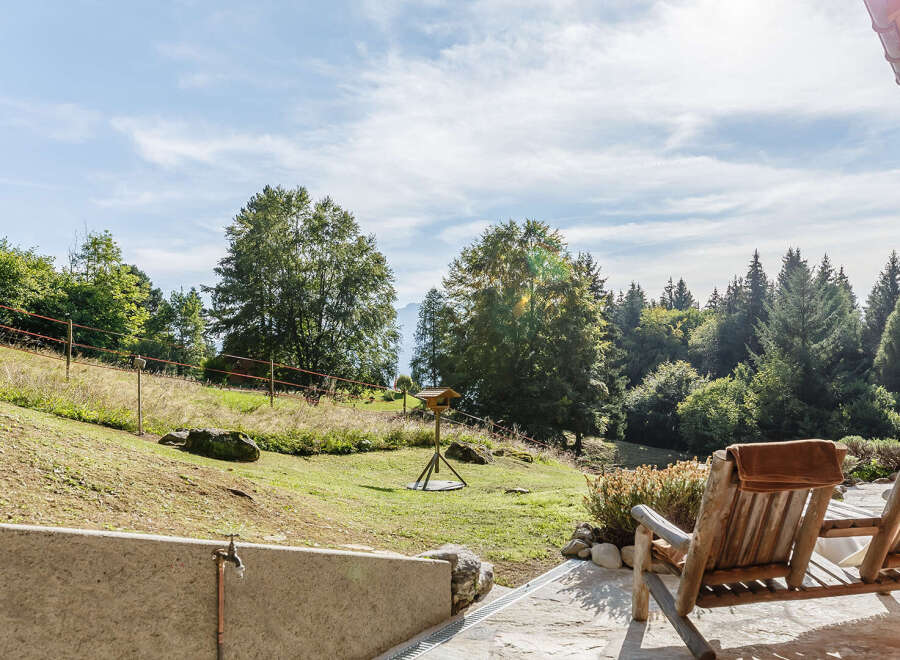 Enjoy breathtaking views from this stunning property! This home features a spacious outdoor area with comfortable seating, perfect for relaxing and taking in the natural beauty.