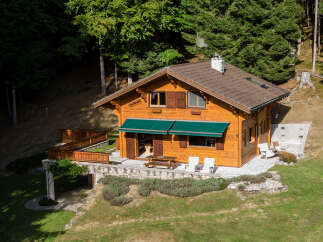 Nestled in a serene forest setting, this charming wooden cabin offers a perfect blend of rustic charm and modern comfort.