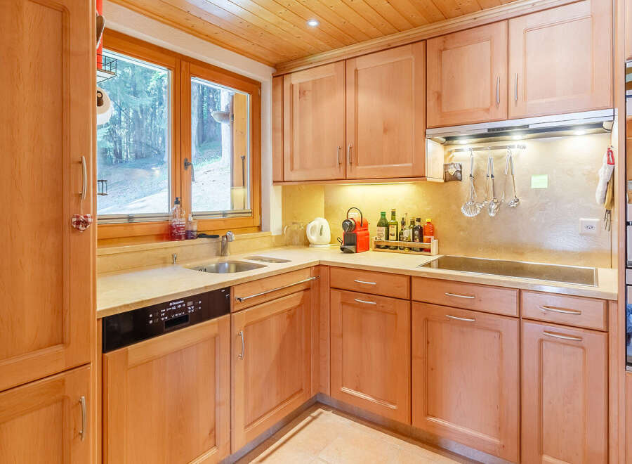 This charming kitchen boasts a warm, inviting atmosphere with its wooden cabinetry and countertops.