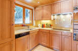 This charming kitchen boasts a warm, inviting atmosphere with its wooden cabinetry and countertops.