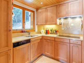 This charming kitchen boasts a warm, inviting atmosphere with its wooden cabinetry and countertops.