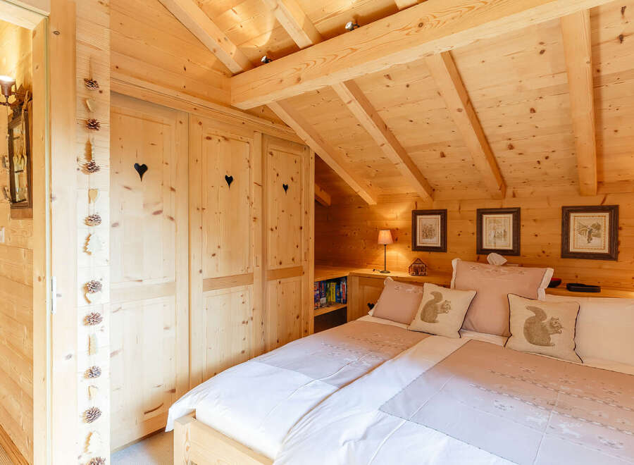 This cozy bedroom features a charming wooden interior, creating a warm and inviting atmosphere.