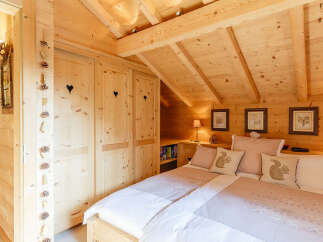 This cozy bedroom features a charming wooden interior, creating a warm and inviting atmosphere.