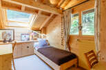 This charming bedroom features a cozy, wooden interior, creating a warm and inviting atmosphere.