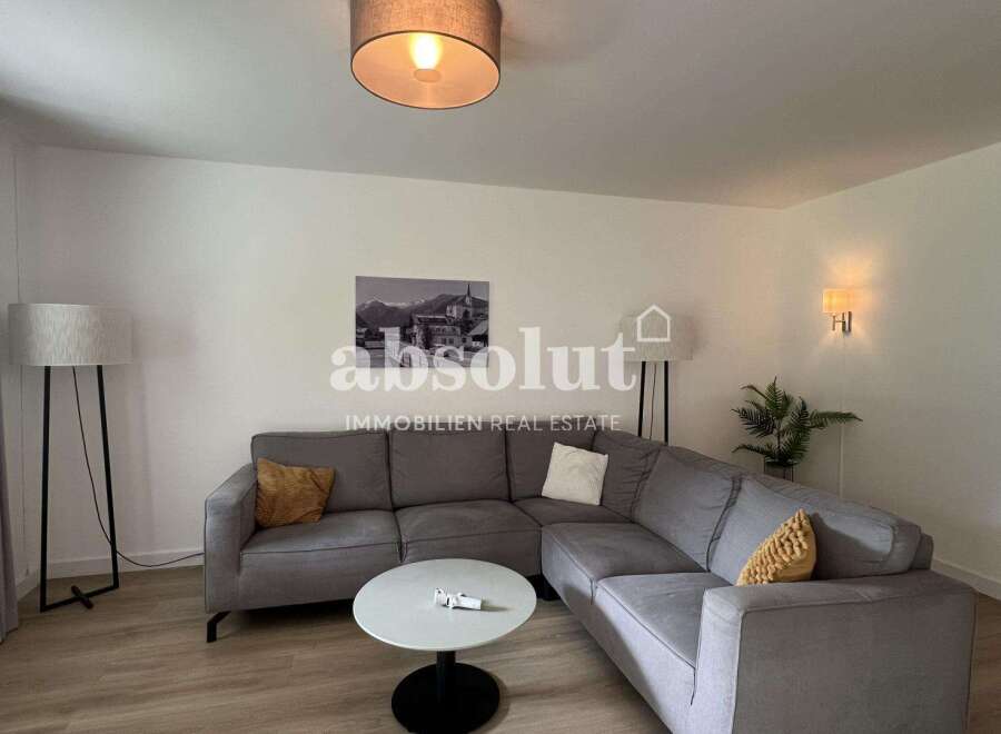 Discover modern living in this stylish property, featuring a spacious living room with a comfortable sectional sofa.