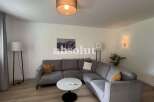 Discover modern living in this stylish property, featuring a spacious living room with a comfortable sectional sofa.