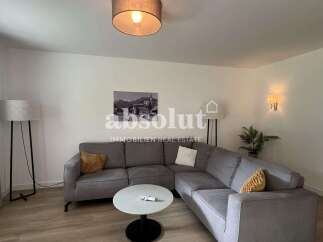 Discover modern living in this stylish property, featuring a spacious living room with a comfortable sectional sofa.