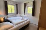 Discover a cozy bedroom with natural light and a comfortable bed, perfect for relaxation.