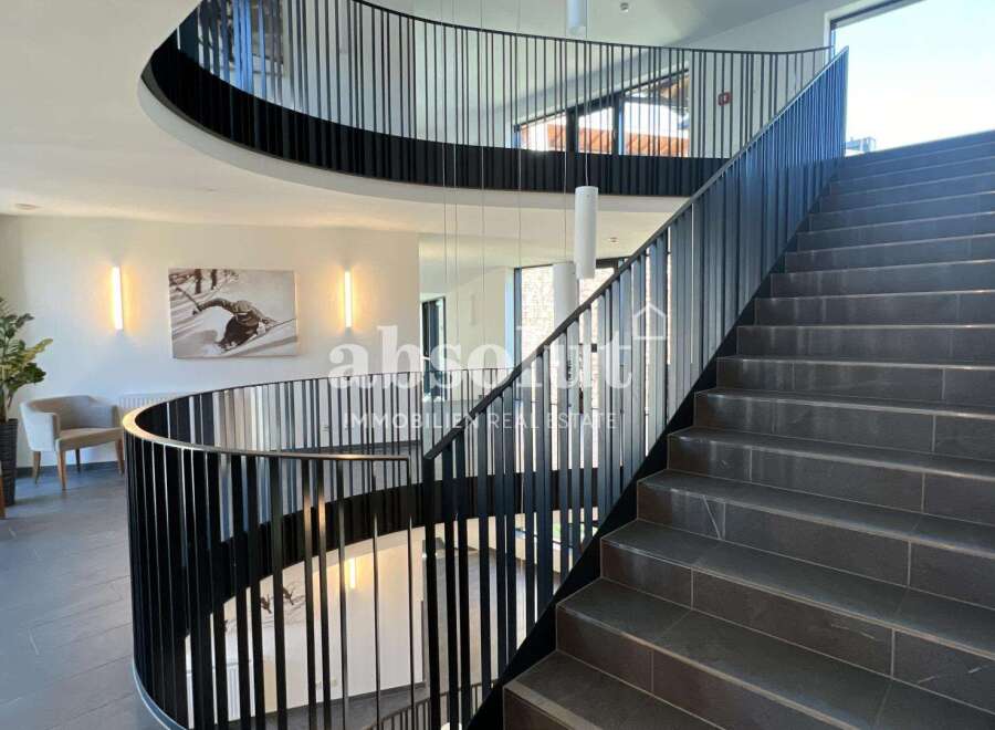 Discover the epitome of modern elegance in this stunning property, featuring a grand staircase that leads to multiple levels.