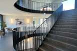 Discover the epitome of modern elegance in this stunning property, featuring a grand staircase that leads to multiple levels.