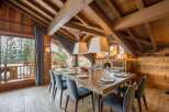 Experience luxury living in this stunning property featuring a spacious dining area with a large wooden table, perfect for hosting gatherings.