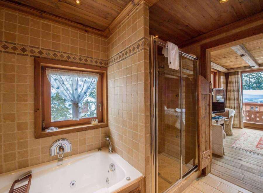Experience luxury in this exquisite bathroom, featuring a jacuzzi tub and a separate shower.