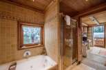 Experience luxury in this exquisite bathroom, featuring a jacuzzi tub and a separate shower.