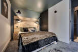 This cozy bedroom features a rustic wooden headboard, creating a warm and inviting atmosphere.