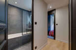 Step into modern elegance with this stunning property, featuring a beautifully designed bathroom with sleek gray tiles and a glass shower enclosure.