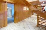 This stunning property boasts a warm and inviting interior with beautiful wooden accents throughout.