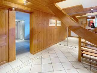 This stunning property boasts a warm and inviting interior with beautiful wooden accents throughout.