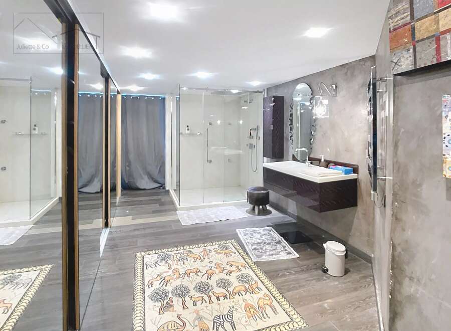 Step into luxury with this stunning bathroom, featuring a sleek, modern design.