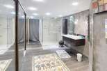 Step into luxury with this stunning bathroom, featuring a sleek, modern design.