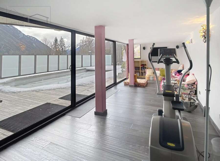 This stunning property boasts a modern gym with panoramic mountain views, perfect for maintaining a healthy lifestyle.