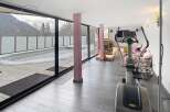 This stunning property boasts a modern gym with panoramic mountain views, perfect for maintaining a healthy lifestyle.