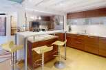 This stunning kitchen boasts modern design with sleek cabinetry and a breakfast bar, perfect for entertaining.