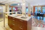 This stunning kitchen boasts a modern design with sleek cabinetry and a spacious layout, perfect for culinary enthusiasts.