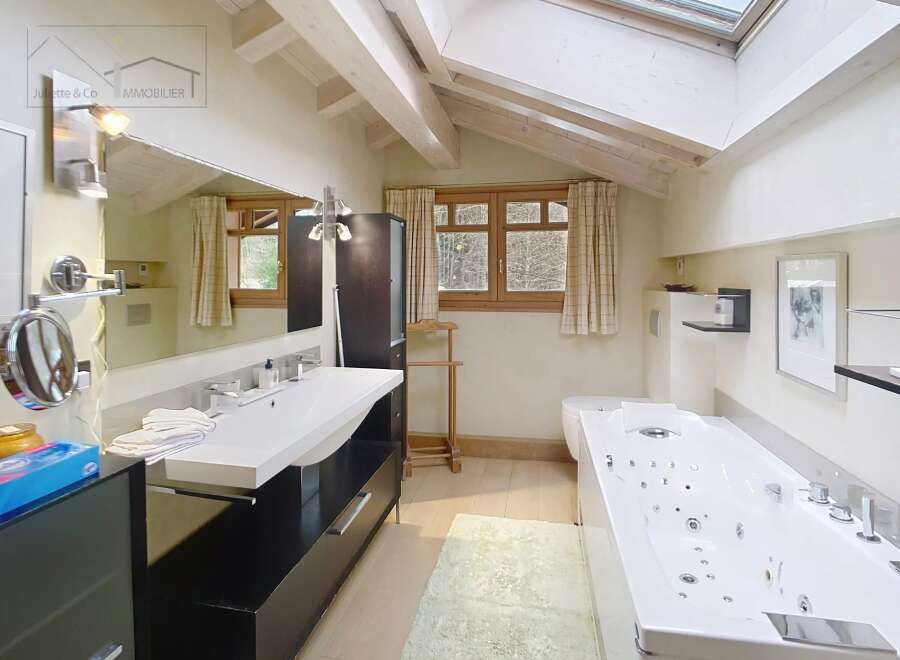 This luxurious bathroom features a modern design with a spacious layout.