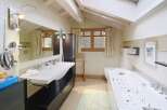 This luxurious bathroom features a modern design with a spacious layout.