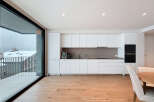 Experience modern living in this stunning kitchen, featuring sleek white cabinetry and a contemporary design.