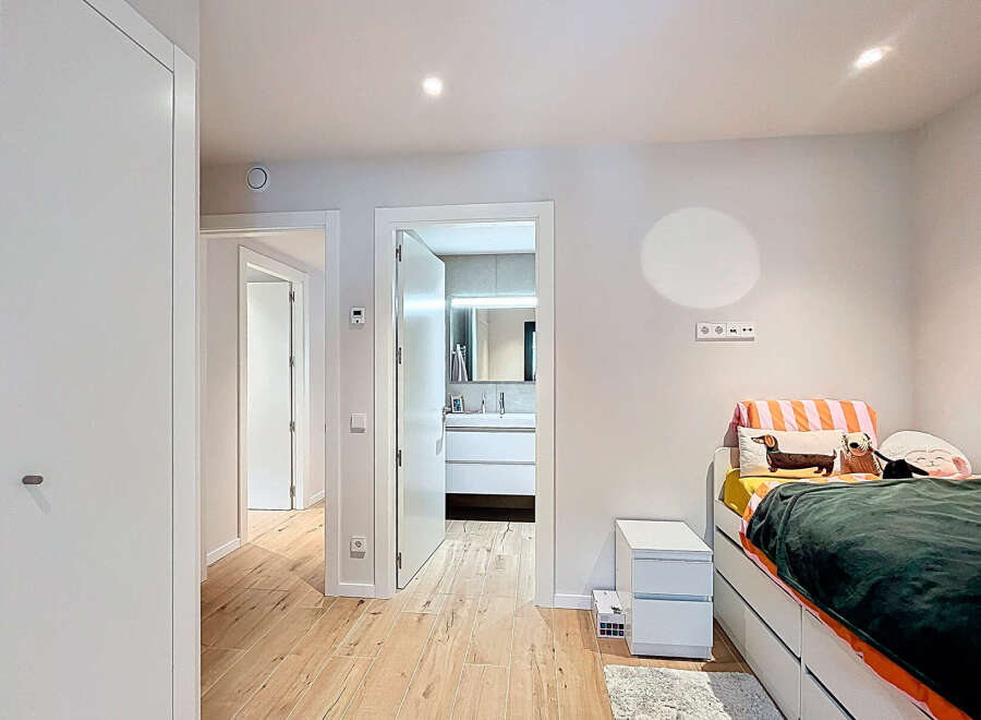 This bright and airy bedroom boasts a modern design with clean lines and neutral tones.
