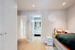 This bright and airy bedroom boasts a modern design with clean lines and neutral tones.