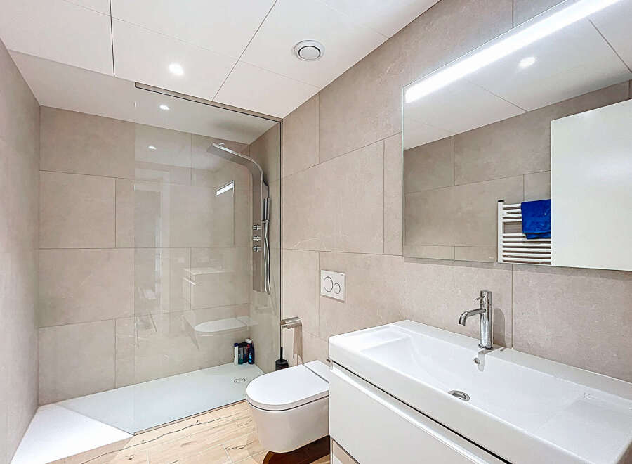 Step into a modern bathroom oasis! This stunning space features a sleek glass shower enclosure, a contemporary vanity with a stylish faucet, and elegant tile work throughout.