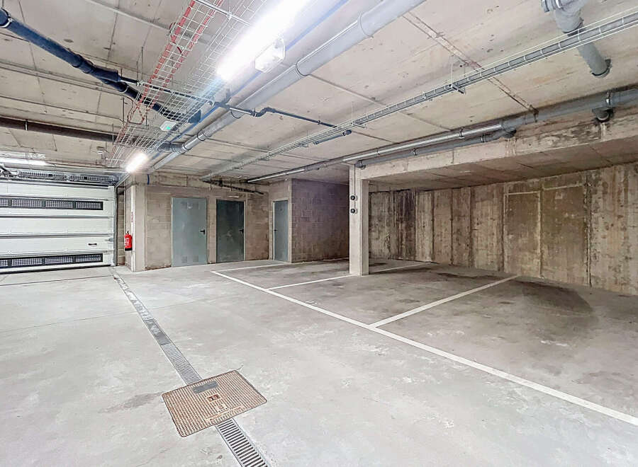 This image showcases a well-lit, spacious parking garage, perfect for secure vehicle storage.