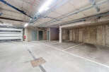 This image showcases a well-lit, spacious parking garage, perfect for secure vehicle storage.