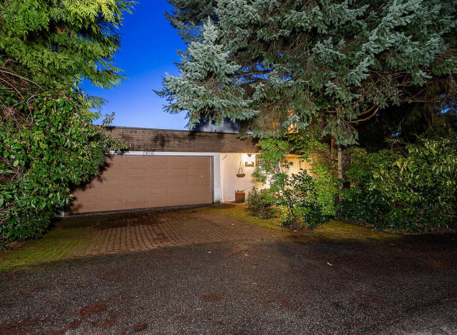 Discover the charm of this stunning property, featuring a beautifully designed garage and a welcoming facade.