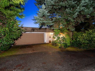 Discover the charm of this stunning property, featuring a beautifully designed garage and a welcoming facade.