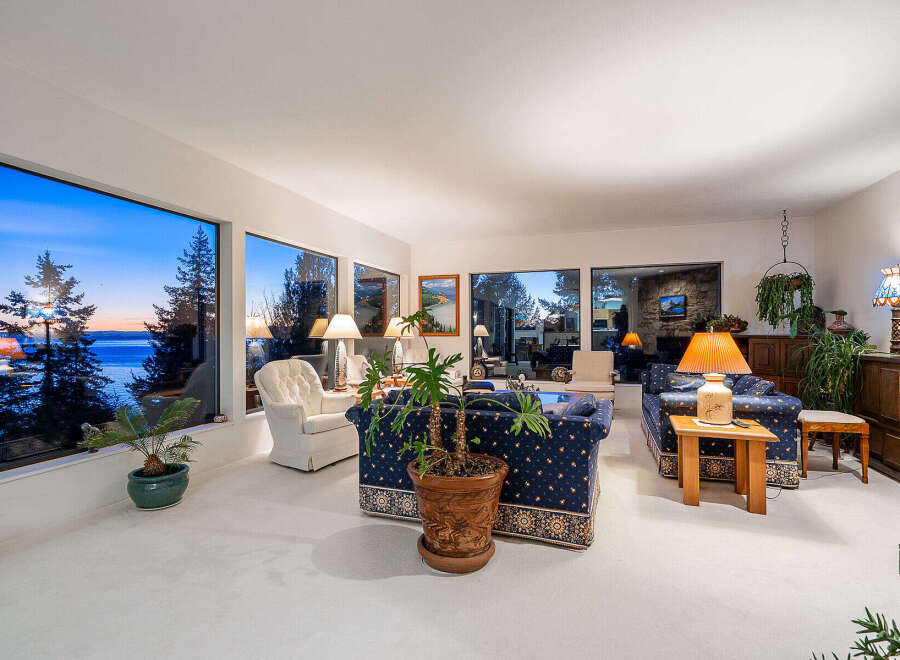 Experience breathtaking views from this stunning property, featuring expansive windows that frame the serene water and vibrant sunsets.
