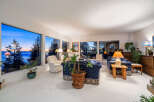 Experience breathtaking views from this stunning property, featuring expansive windows that frame the serene water and vibrant sunsets.