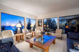 Experience breathtaking views from this stunning living room, featuring expansive windows that frame the serene landscape.
