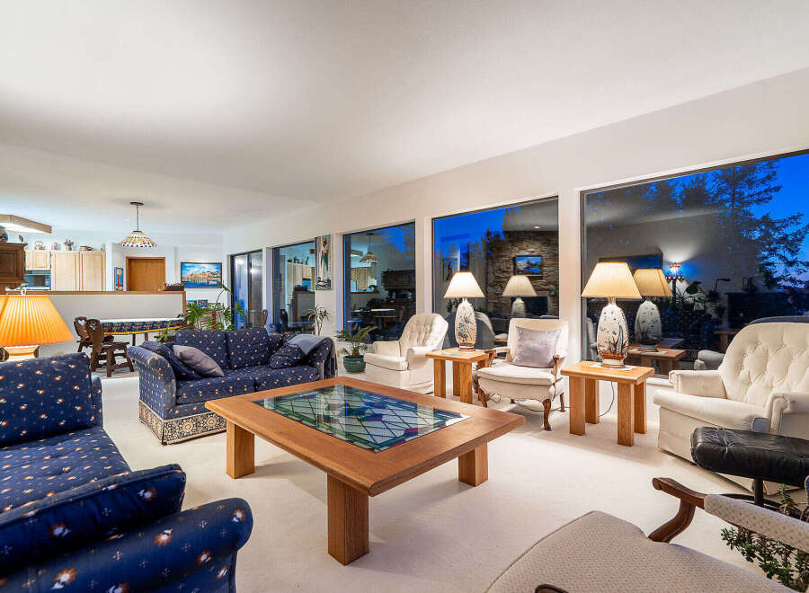 Step into luxury with this stunning living room, boasting expansive windows that frame breathtaking views.