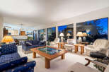 Step into luxury with this stunning living room, boasting expansive windows that frame breathtaking views.