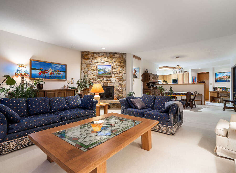 Step into luxury with this stunning living room, featuring a cozy fireplace and elegant seating.