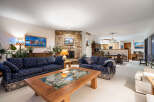 Step into luxury with this stunning living room, featuring a cozy fireplace and elegant seating.
