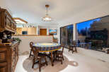 This charming dining room features a round wooden table with seating for four, perfect for intimate gatherings.