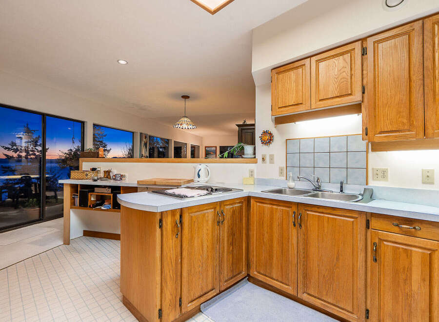This stunning kitchen boasts beautiful wooden cabinetry and a bright, open layout.