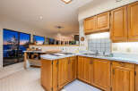 This stunning kitchen boasts beautiful wooden cabinetry and a bright, open layout.